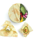 A sealed bowl, and two fruits sealed directly with Bee's Wrap.