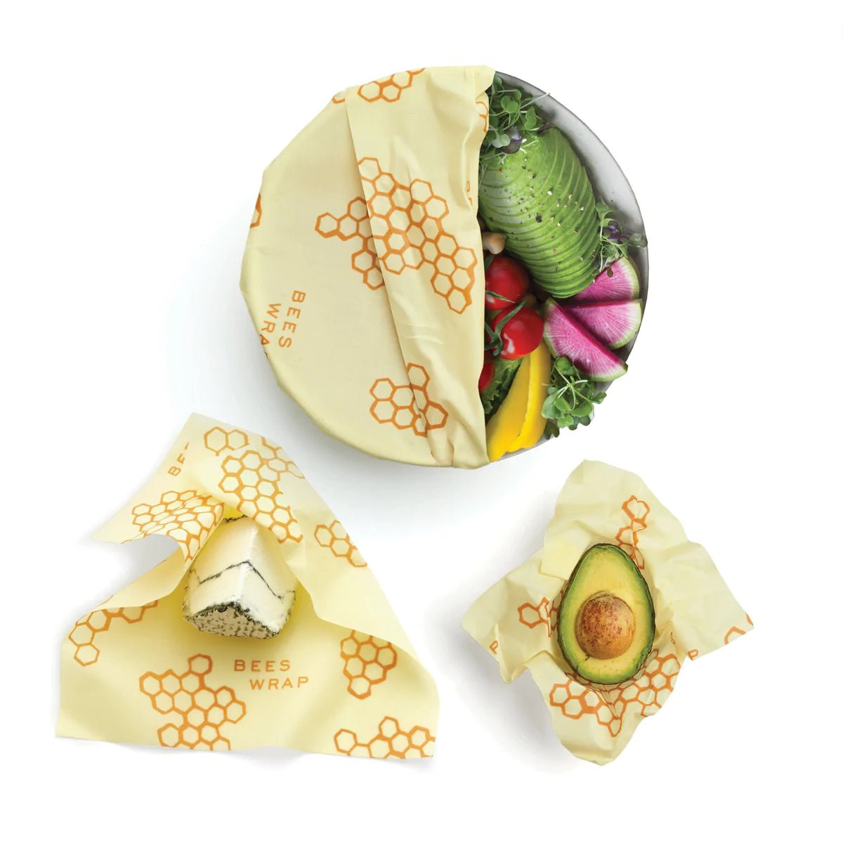 A sealed bowl, and two fruits sealed directly with Bee's Wrap.