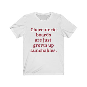 A white T-shirt that reads "Charcuterie boards are just grown up Lunchables." in red text.