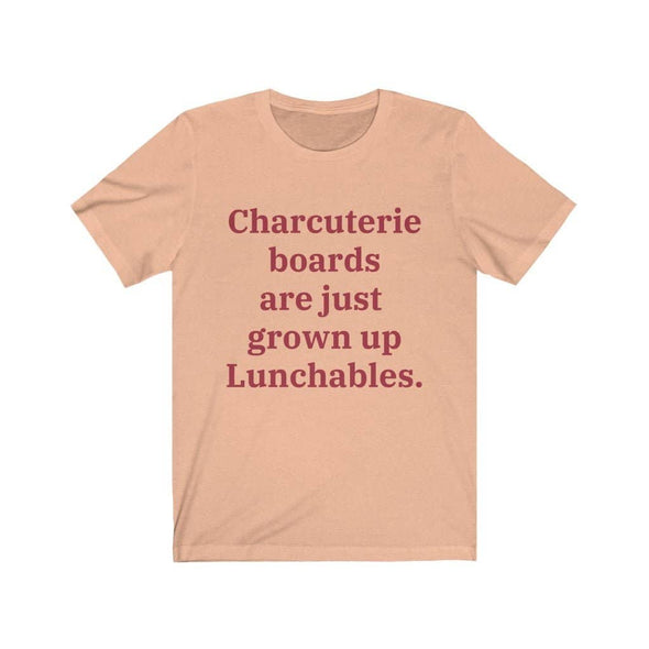 A heather peach colored T-shirt that reads "Charcuterie boards are just grown up Lunchables." in red text.