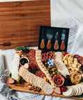 Cheese, meat, crackers, spreadables, olives, nuts, chocolates, knives, and a handcrafted wooden board Everything you need to create the best charcuterie board