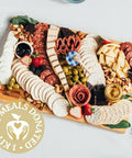 Cheese, meat, crackers, spreadables, olives, nuts and chocolates. Everything you need to create the best charcuterie board that is sure to leave your friends and family drooling!