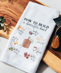 Kitchen towel with instructions on how to build a charcuterie board.